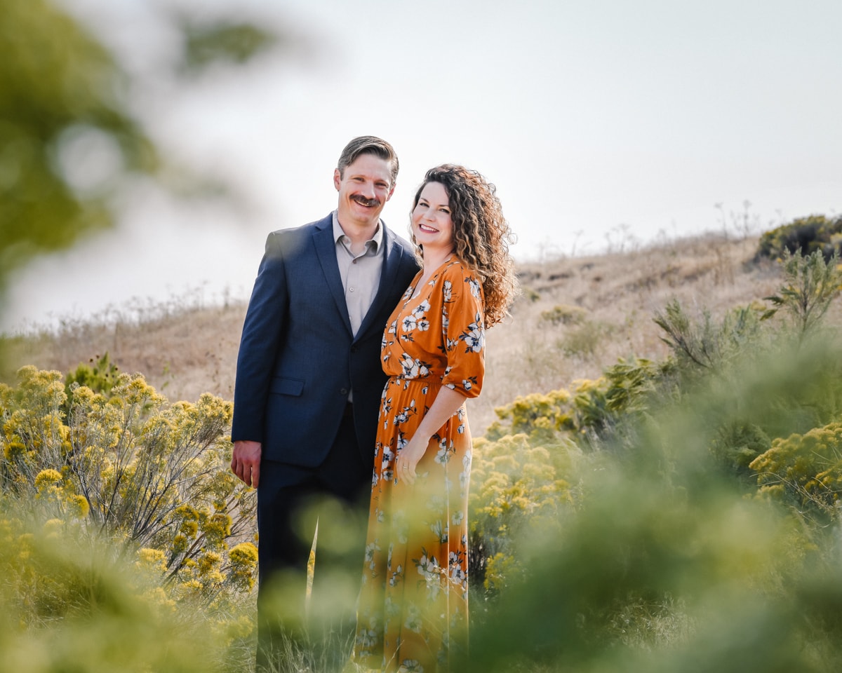 Couple smiling together in desert landscape — Chrissy Ray Photography