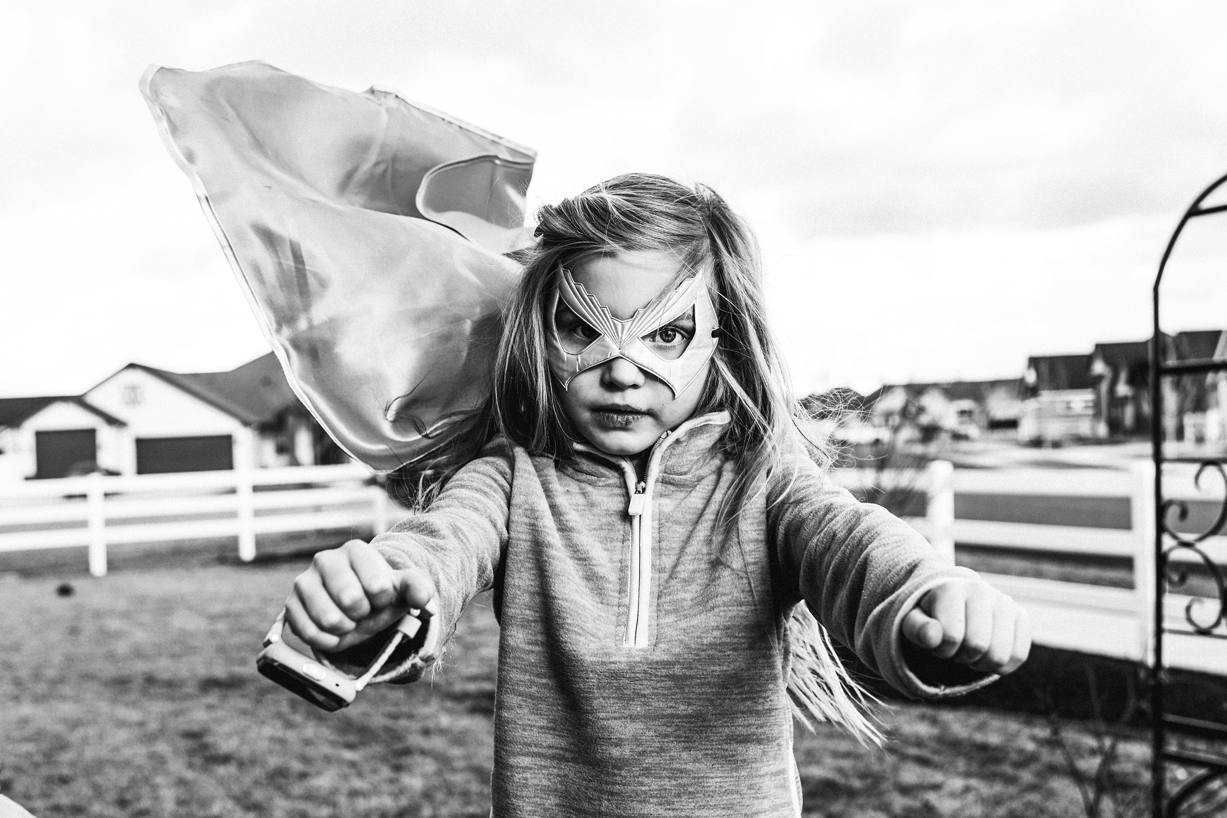 Child in superhero cape flying over farm — IdaHOPE session Eagle Idaho