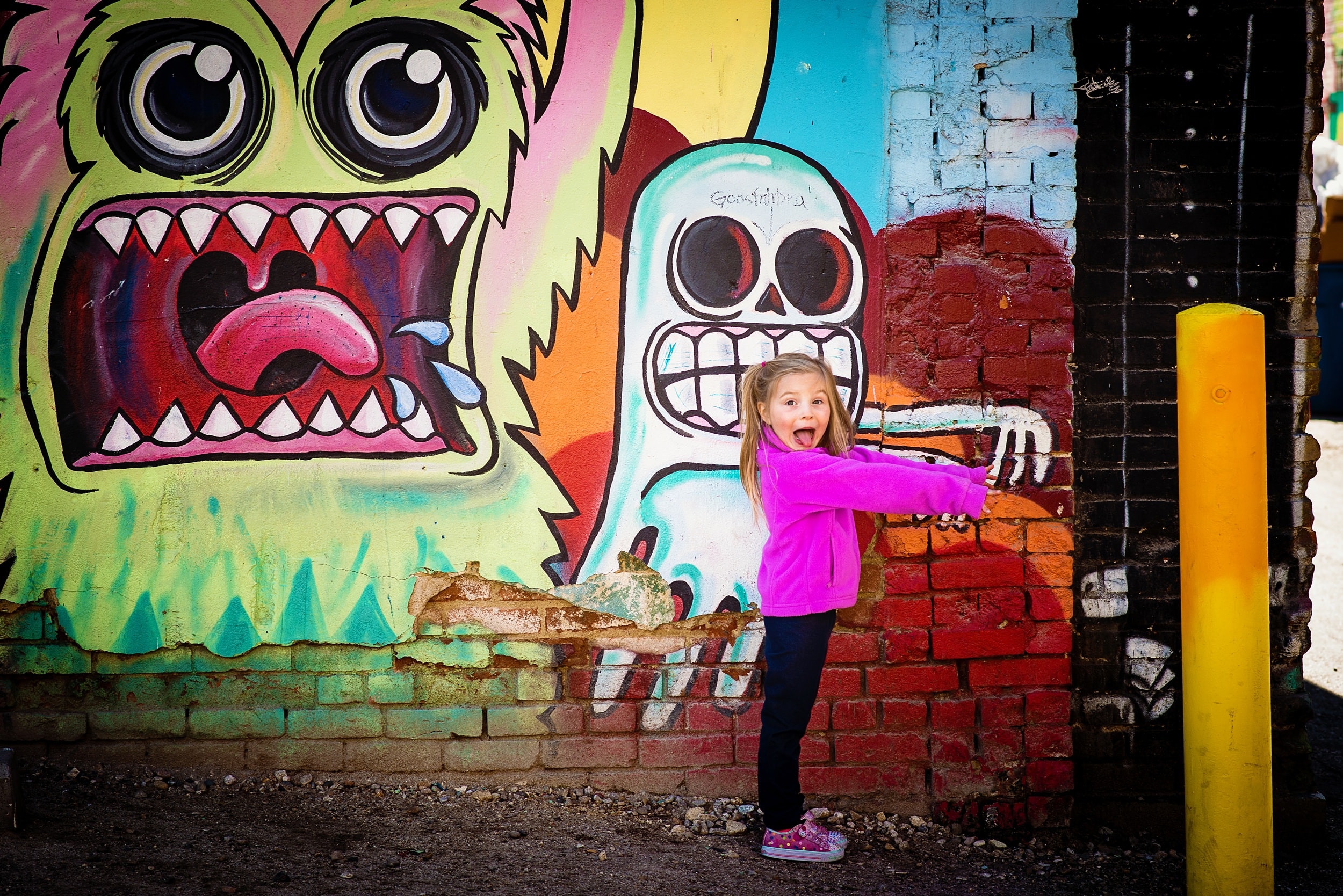 Child posing with colorful monster street art — IdaHOPE session by Chrissy Ray Photography