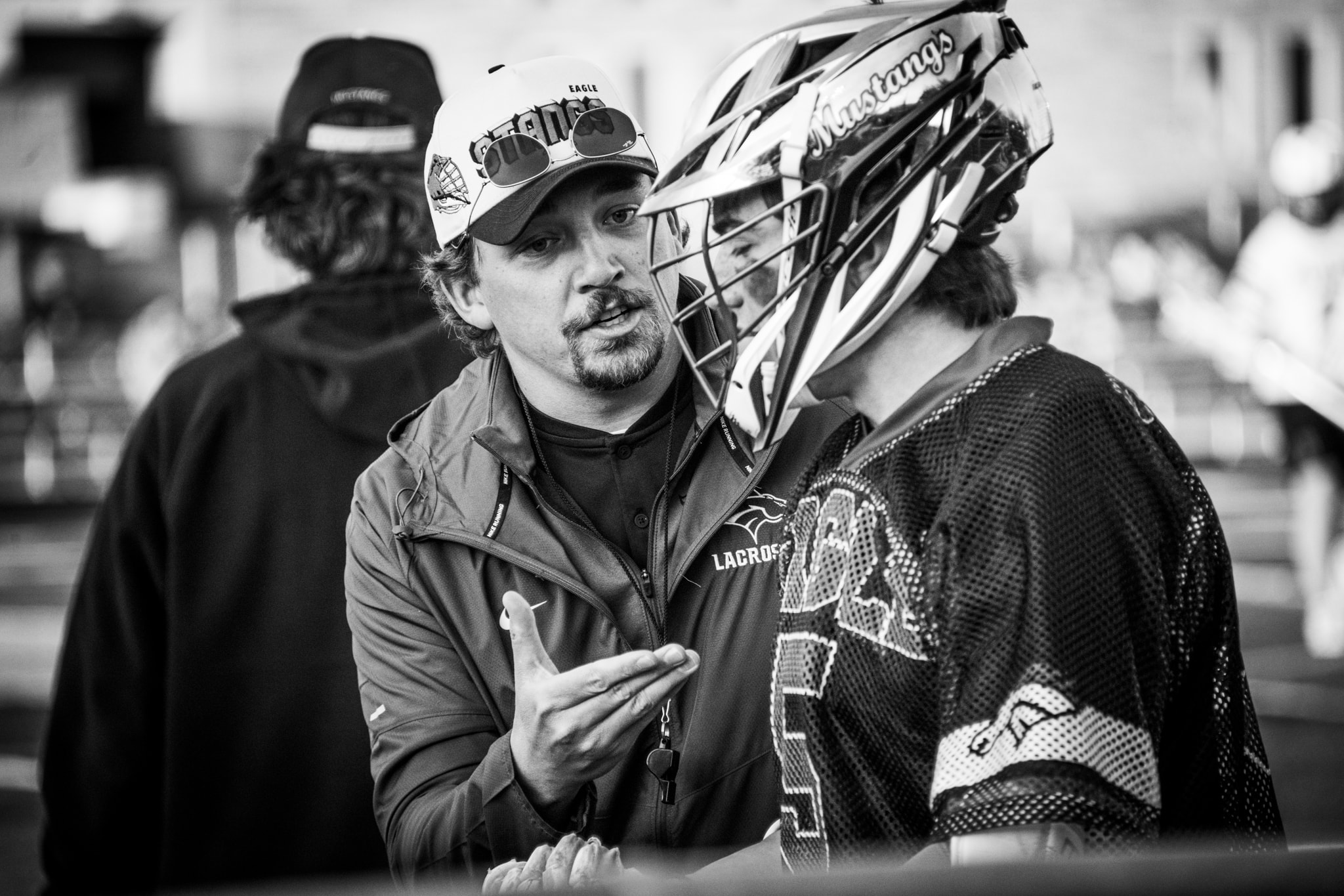 Lacrosse coach instructing player during game — Eagle Idaho sports coverage