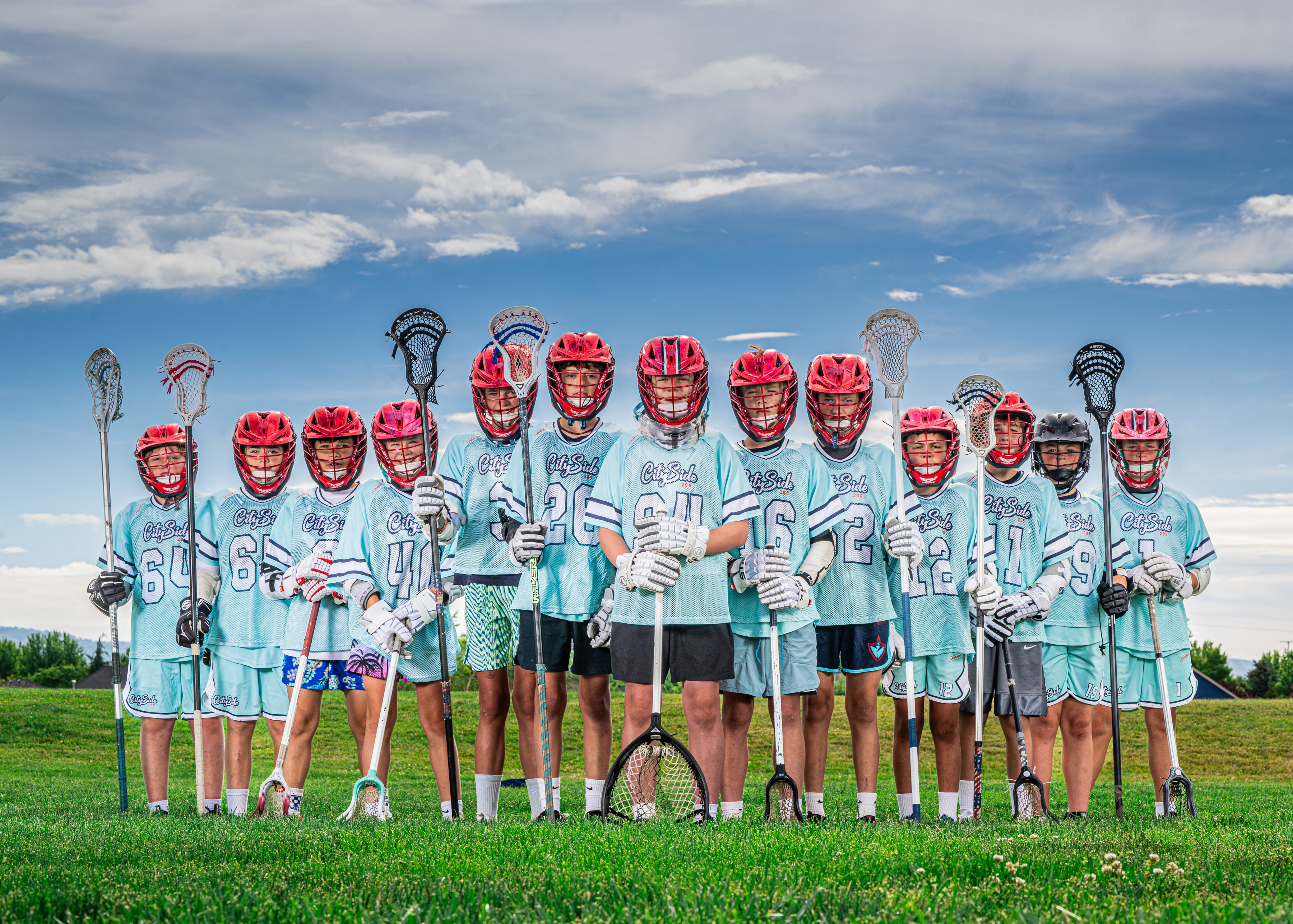 Youth lacrosse team posing for field portrait — league team photography Idaho