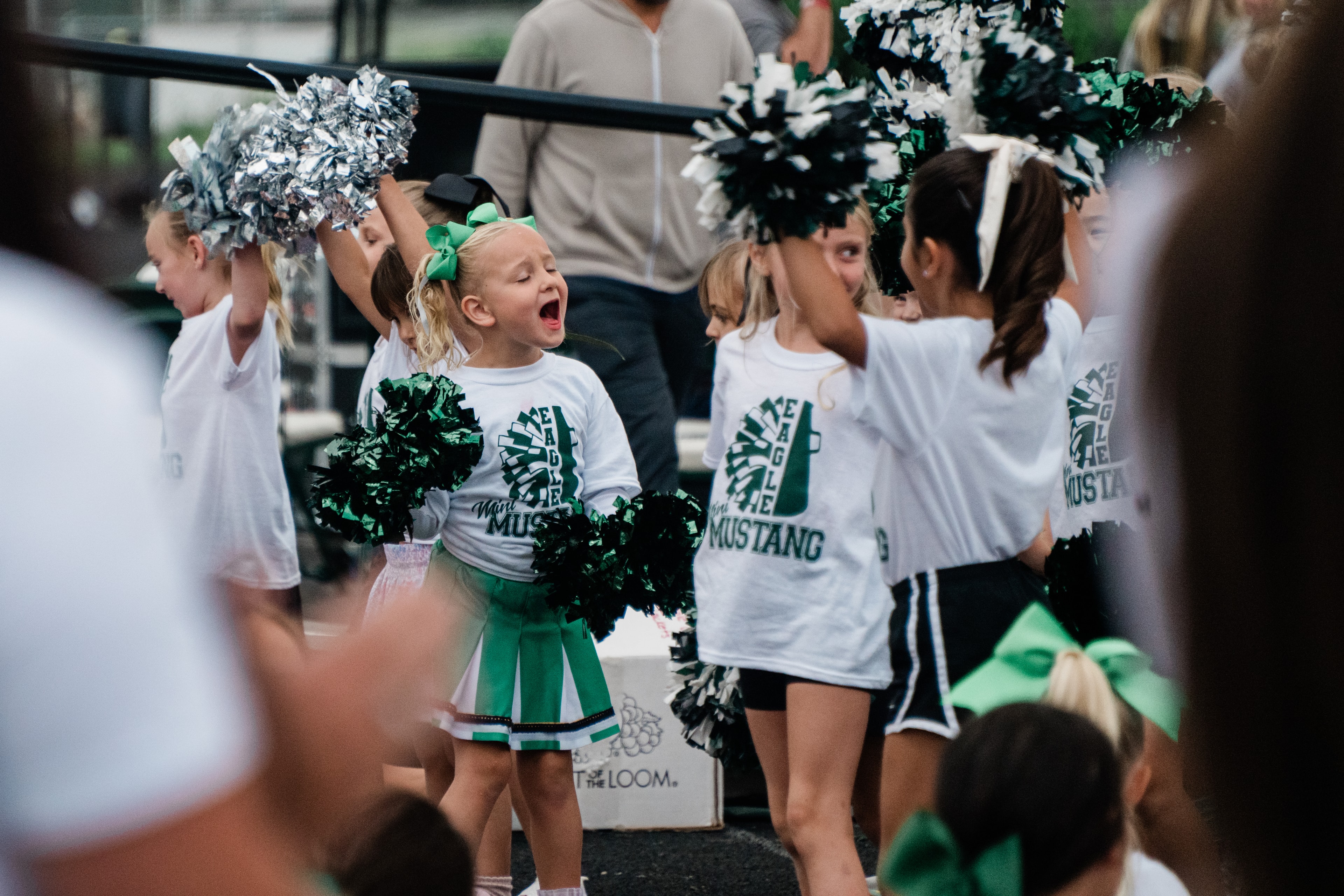 Young cheerleaders performing with green pom poms — Eagle Idaho cheer photography