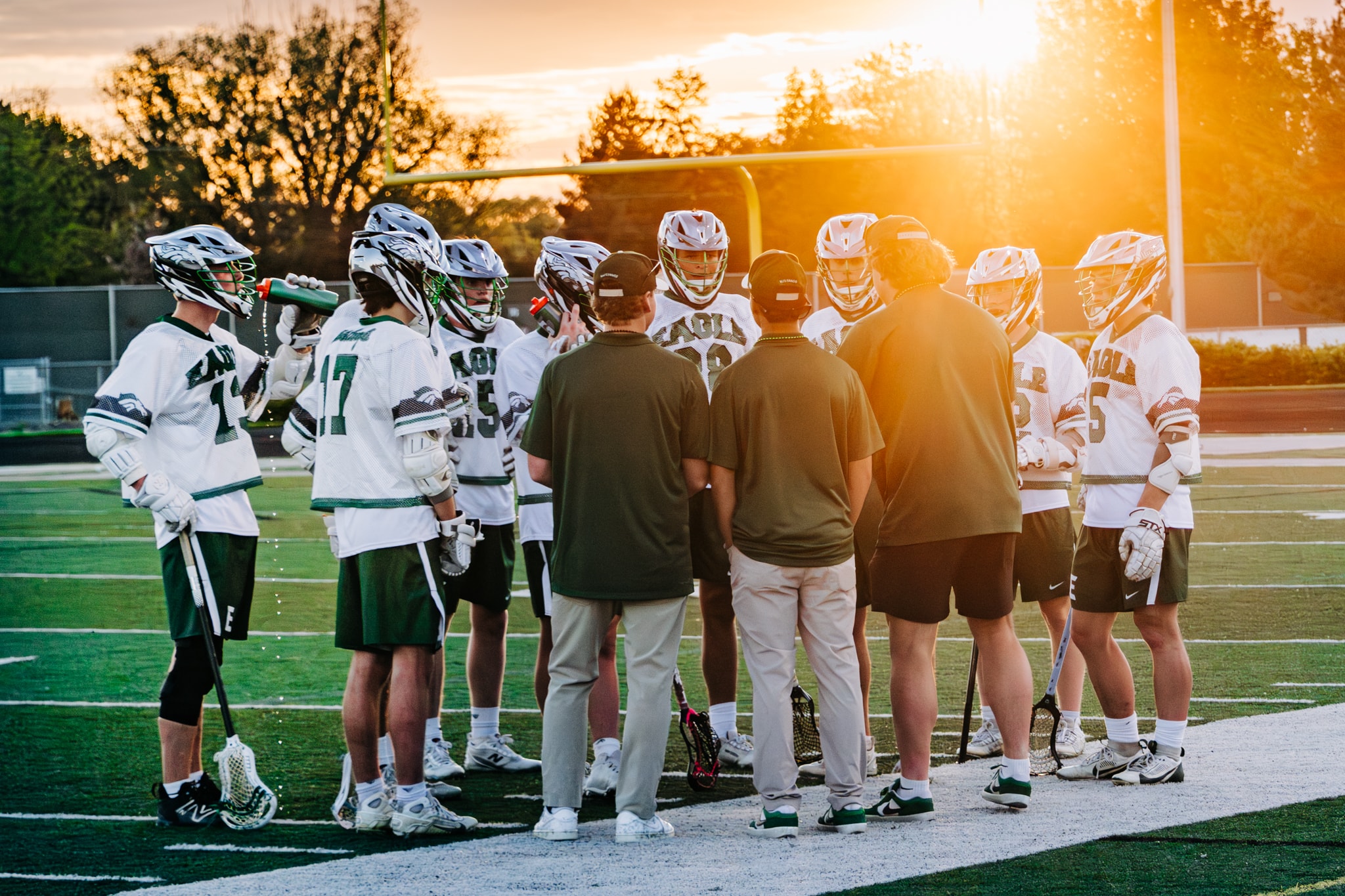 Lacrosse team huddle at sunset practice — Eagle Idaho league photography