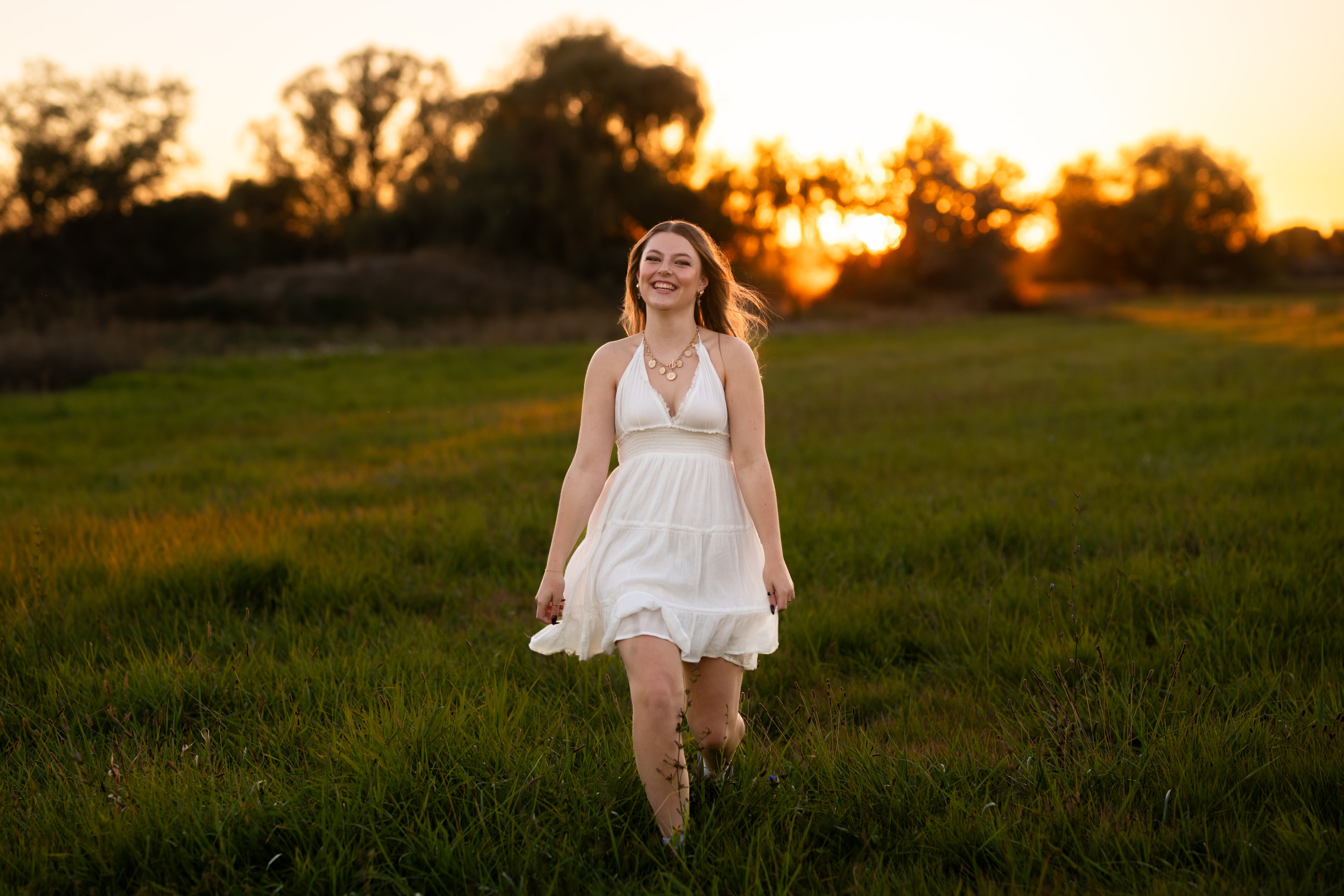 Idaho senior portraits — girl in white dress running through field