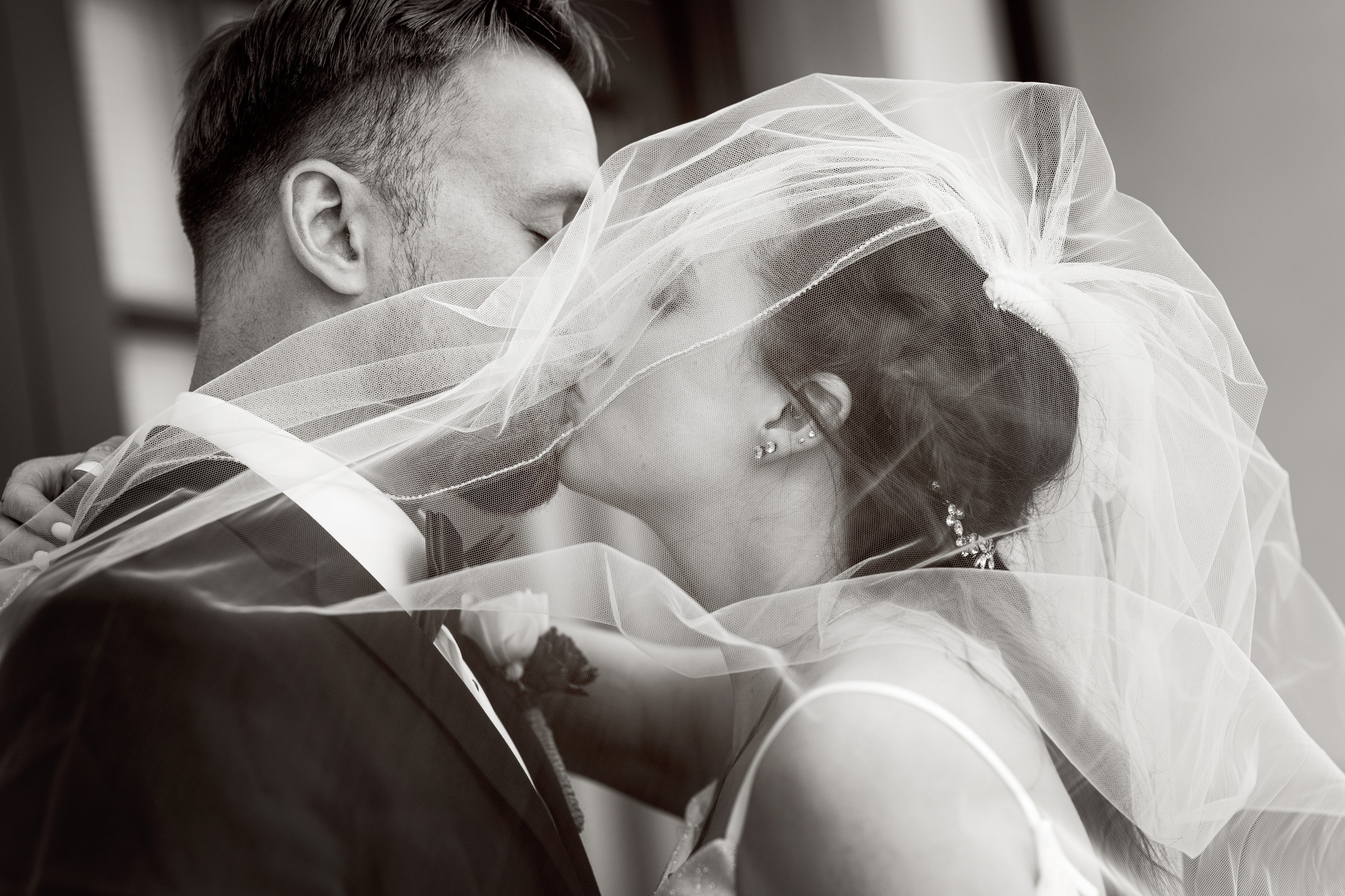 Bride and groom kissing under veil — Treasure Valley wedding photographer
