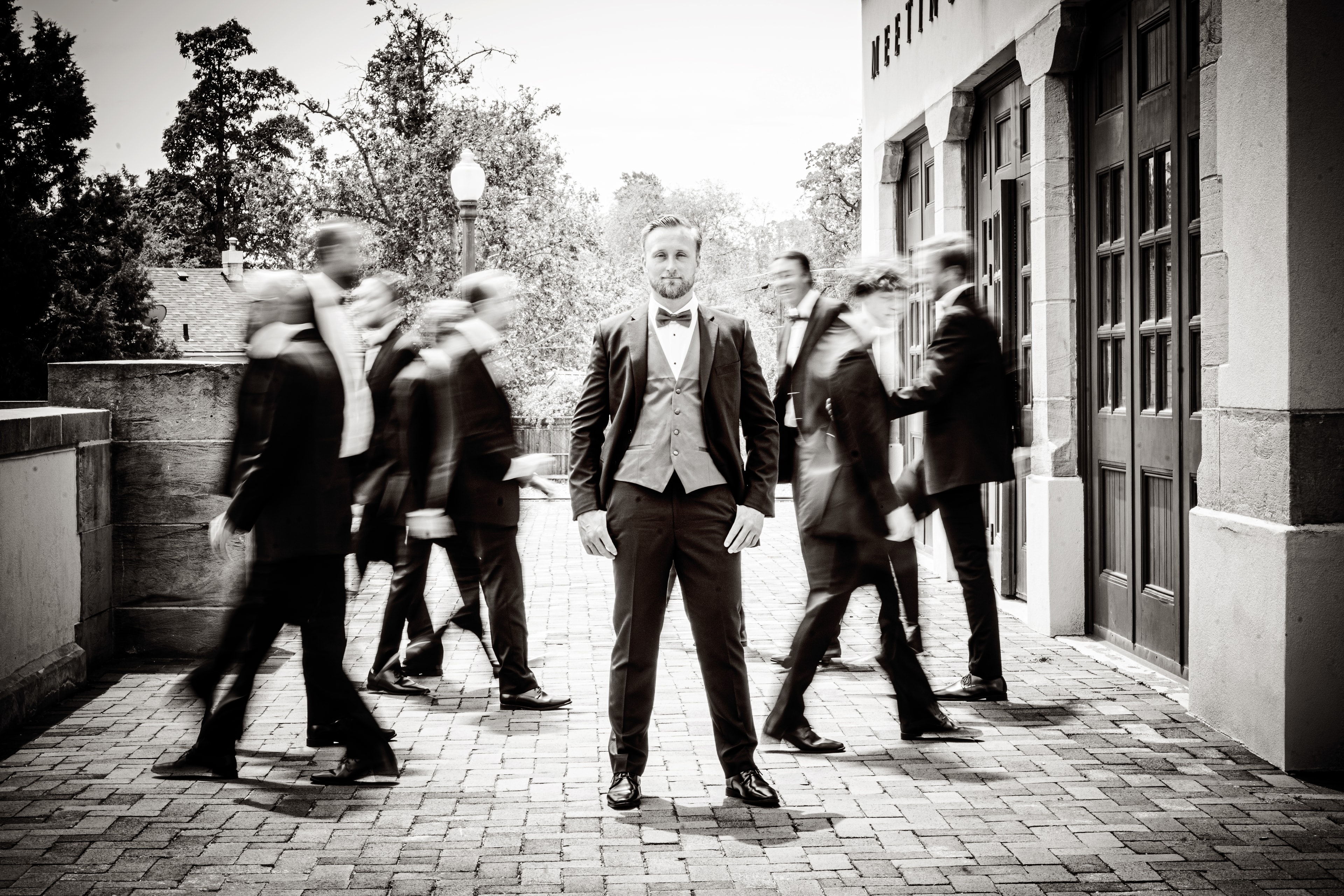 Groom surrounded by groomsmen in motion — Treasure Valley wedding photography