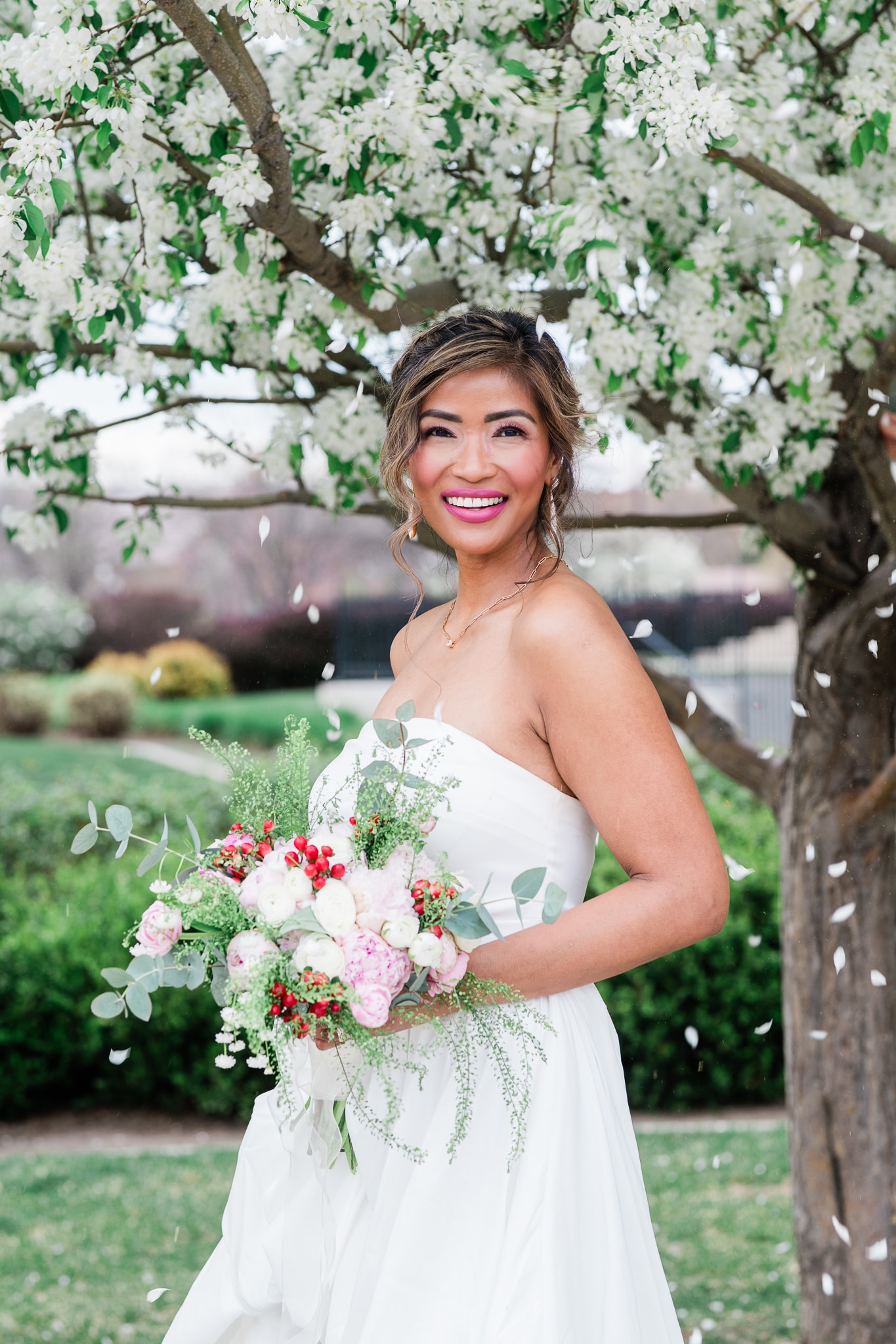 Bride holding bouquet under flowering tree — Boise Idaho wedding photographer