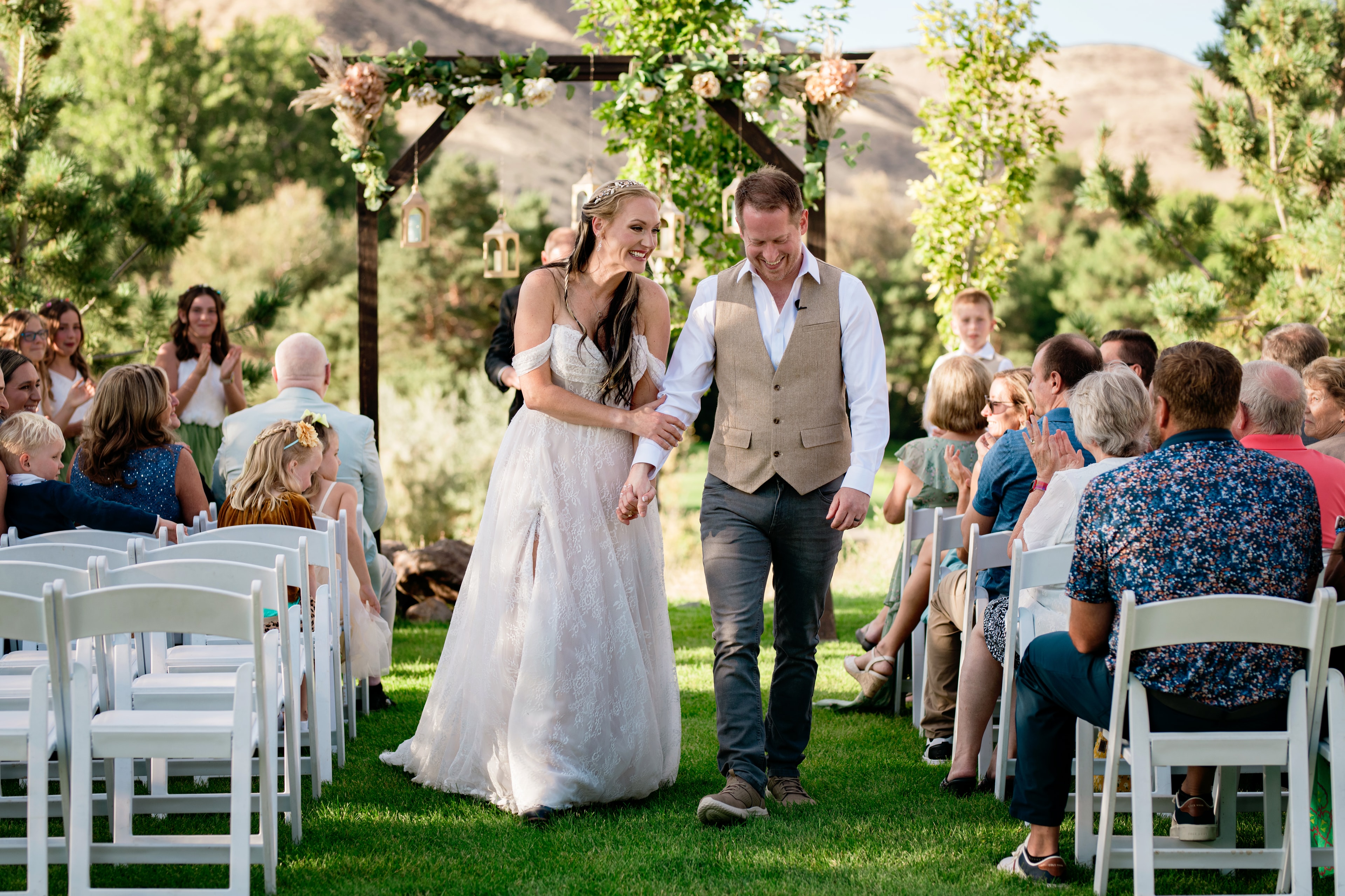 Couple walking through outdoor garden wedding ceremony — Treasure Valley