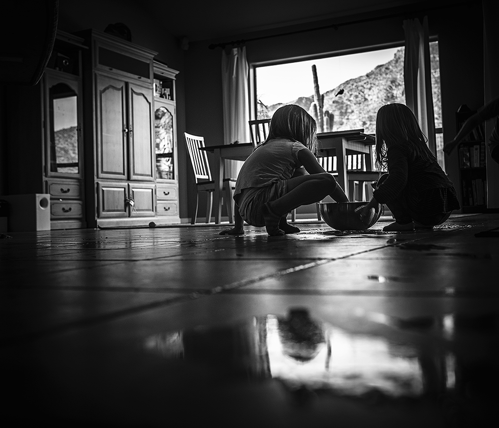 Two girls cleaning the floor